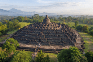 cinematic travel photography of Borobudur Temple near Yogyakarta, Indonesia, majestic ancient Buddhist stupas and intricate stone architecture,