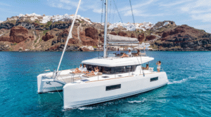 luxury catamaran sailing through the crystal-clear Aegean Sea around Santorini, Greece,