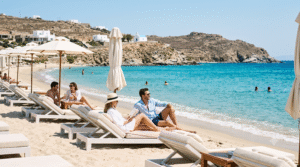 beach lifestyle photograph on a beautiful Mykonos beach, crystal-clear turquoise Aegean water