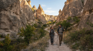 outdoor adventure photograph of two adult travellers hiking through a narrow Cappadocian valley in Turkey,