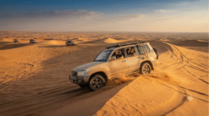 photograph in the Dubai desert, United Arab Emirates, adult travellers enjoying a guided 4x4 dune safari on dramatic golden sand dunes,