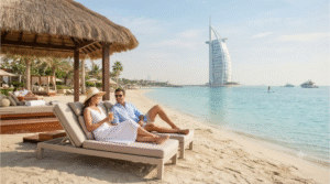 luxury beach lifestyle photograph at Jumeirah Beach, Dubai, United Arab Emirates, adult couple relaxing beside clear turquoise Arabian Gulf water