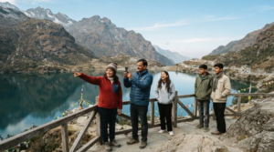 travel photograph of random diverse Indian tourists visiting Tsomgo Lake, surrounded by rugged Himalayan mountains