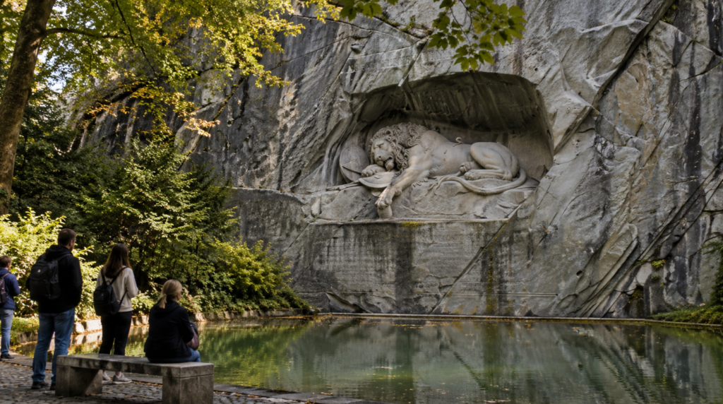 Documentary-style photograph of the Lion Monument in Lucerne, detailed stone lion sculpture carved into natural rock above a small reflective pond