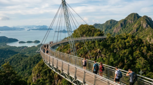 professional travel photograph of Langkawi Sky Bridge in Malaysia, dramatic curved pedestrian bridge suspended high above lush tropical rainforest on Machinchang Mountain,