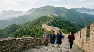 premium travel photograph of the Great Wall of China near Beijing, China, ancient stone wall winding dramatically across green mountain ridges,
