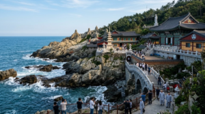 travel photograph of Haedong Yonggungsa Temple in Busan, South Korea, traditional Korean Buddhist temple architecture built dramatically along rugged coastline,