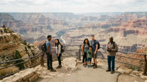 premium travel photograph of diverse random international tourists standing at a dramatic Grand Canyon viewpoint,