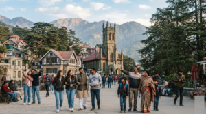 travel photograph of random diverse Indian tourists exploring Shimla's historic Ridge and Mall Road area, surrounded by colonial-era buildings